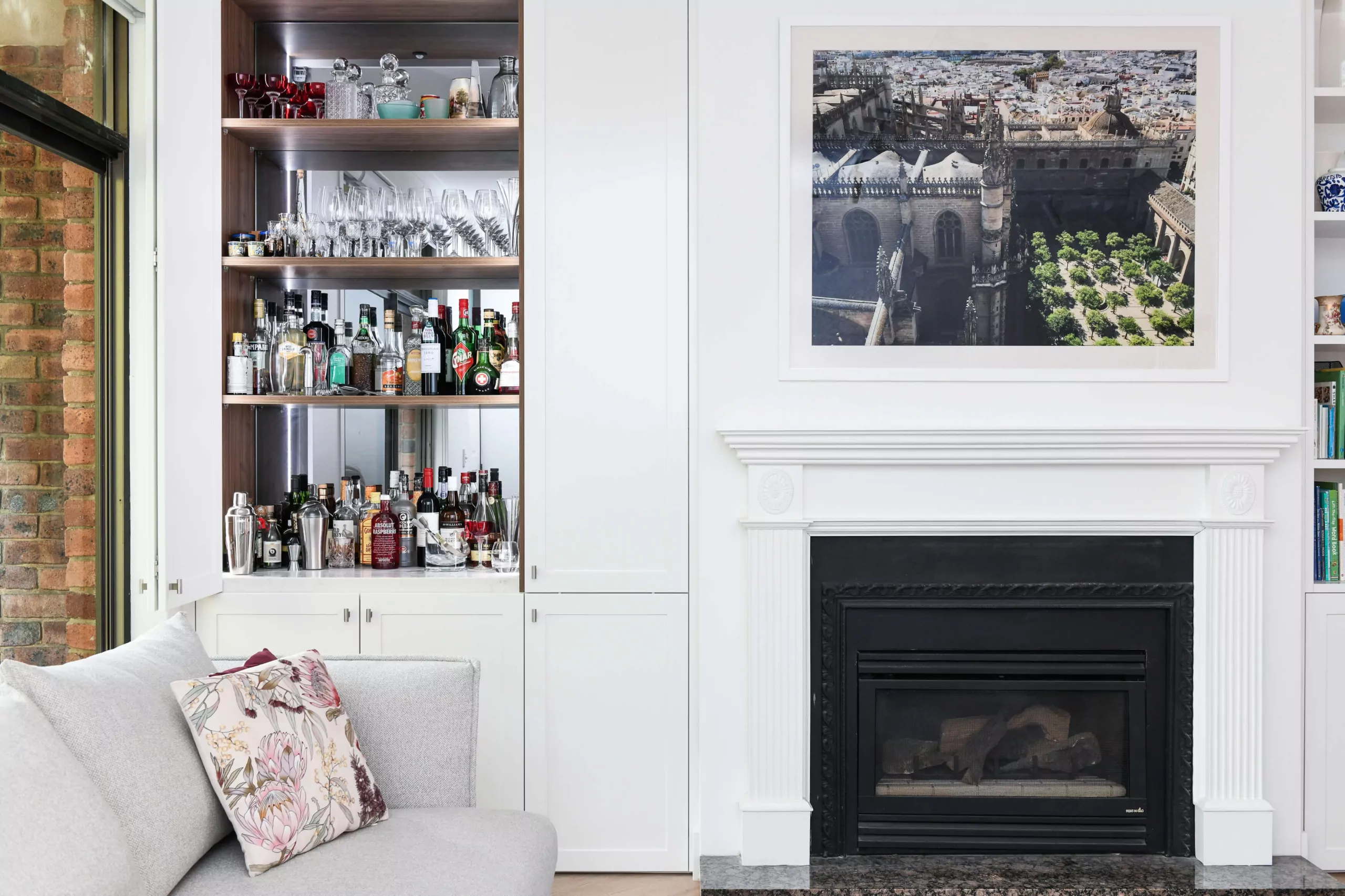 Compact corner bar featuring bifold doors for concealed storage | Custom joinery by Improva, Woollahra