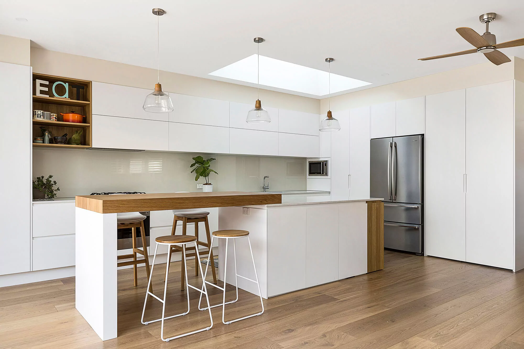 Dual-level kitchen island with raised dining section and timber benchtop | Custom joinery by Improva, Randwick