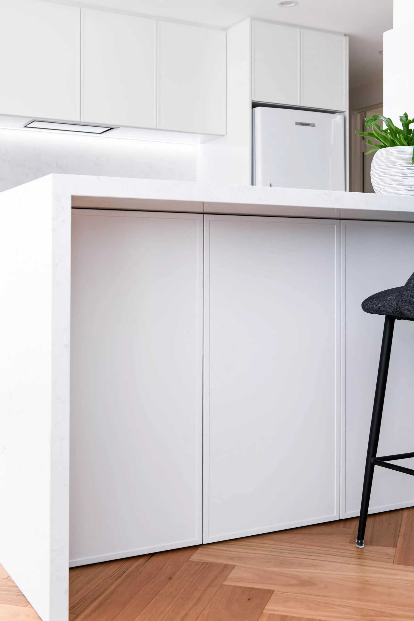 Minimalist white Shaker island with handleless design | Custom joinery by Improva, Redfern