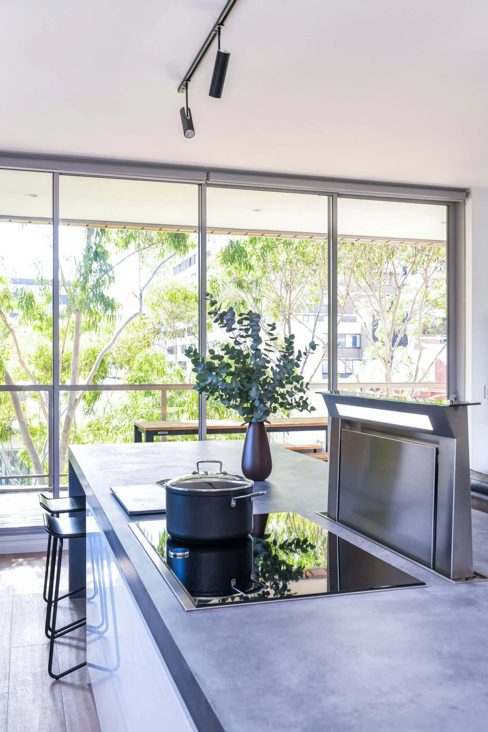 Modern kitchen island with integrated cooktop and pop-up ventilation | Custom joinery by Improva, Zetland
